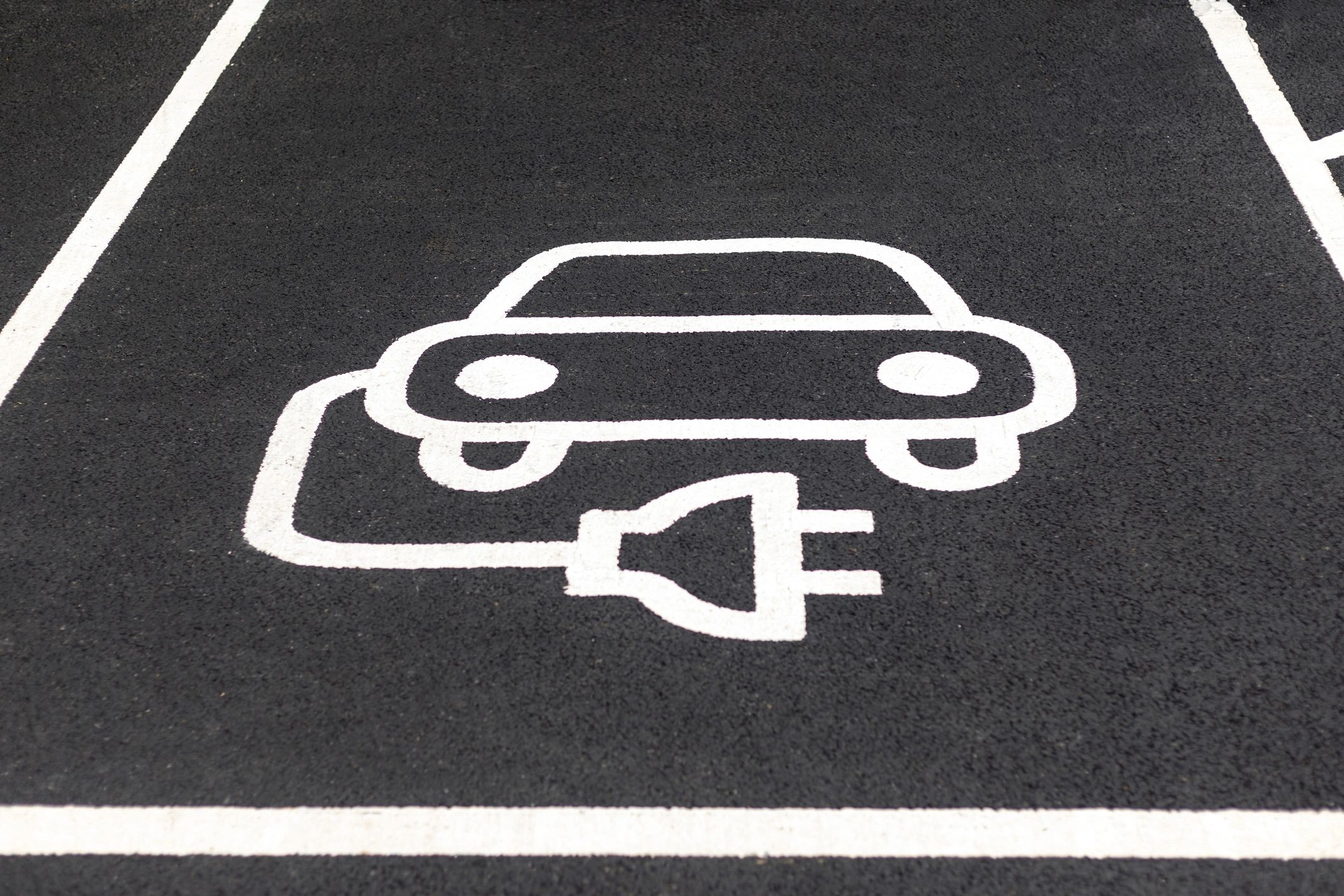 Electric vehicle charging station parking symbol